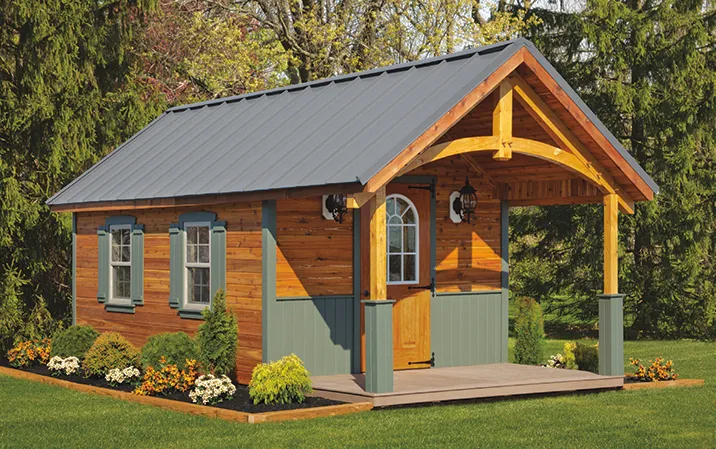 a custom cabin placed in the wood. showcasing a custom cabin build by old glory sheds